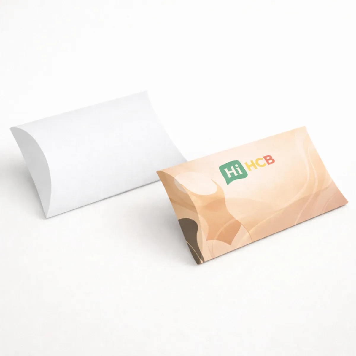 Unique pillow style shapewear boxes with curved edges and a delicate ribbon pull for a luxury feel- class=